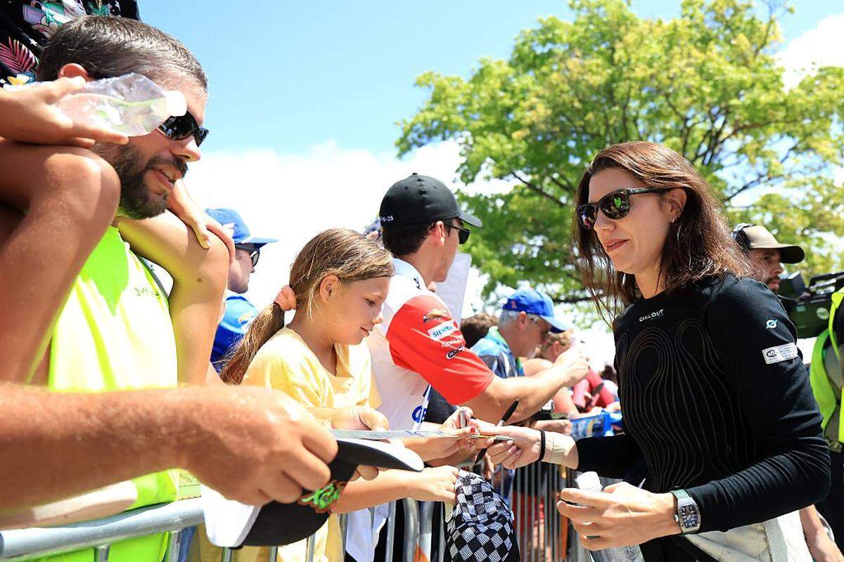 Katherine Legge, driver of the #78 Droplight Chevrolet, signs autographs for NASCAR fans the NASCAR Cup Series Brickyard 400 Presented by PPG at Indianapolis Motor Speedway on July 27, 2025 in Indianapolis, Indiana.