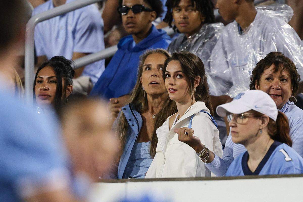 Jordon Hudson, center, girlfriend of UNC Head Coach Bill Belichick, watches the video board from the stands during a timeout at the game between UNC-Charlotte and UNC-Chapel Hill at Jerry Richardson Stadium in Charlotte on Saturday, September 6, 2025.