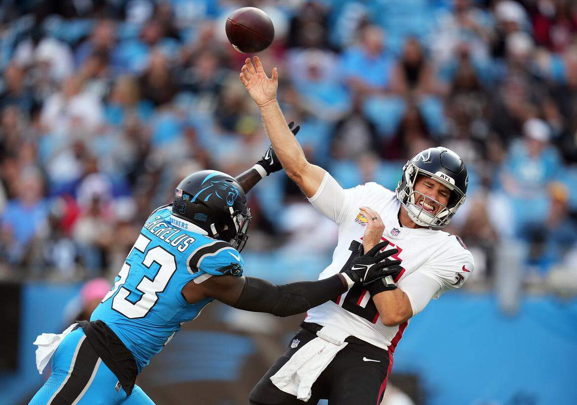 Carolina Panthers linebacker Claudin Cherelus (53) pressures Atlanta Falcons quarterback Kirk Cousins during a 2024 game in Charlotte.