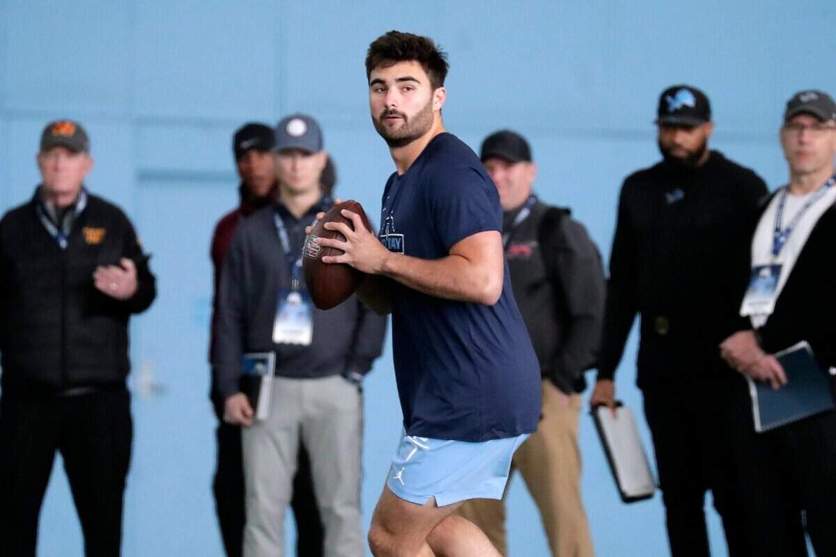 North Carolina quarterback Sam Howell demonstates his skills as NFL scouts look on during Pro Day, Monday, March 28, 2022, in Chapel Hill, N.C. (AP Photo/Chris Seward)