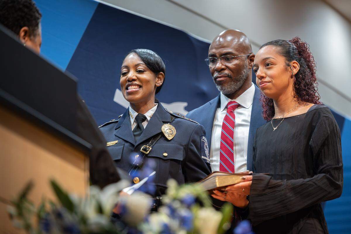 Chief Estella Patterson, left, is sworn in alongside her husband, Lance and her niece, Jaelynn Holder during her swearing in ceremony at the Charlotte Police and Fire Training Academy in Charlotte, N.C., on Friday, December 5, 2025.