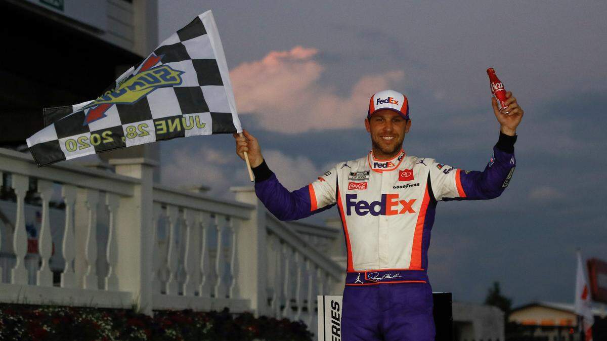 Denny Hamlin celebrates after winning the NASCAR Cup Series auto race at Pocono Raceway, Sunday, June 28, 2020, in Long Pond, Pa. (AP Photo/Matt Slocum)