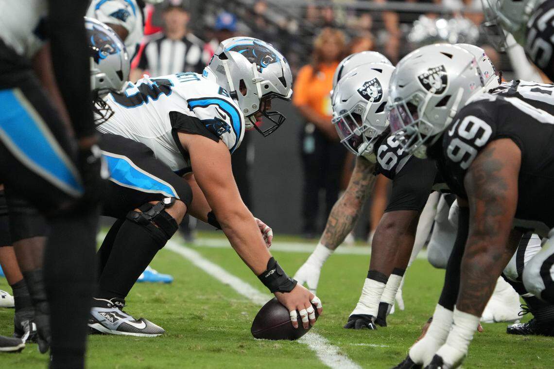 Carolina Panthers center Austin Corbett (63) snaps the ball against the Las Vegas Raiders at Allegiant Stadium during a 2024 game.