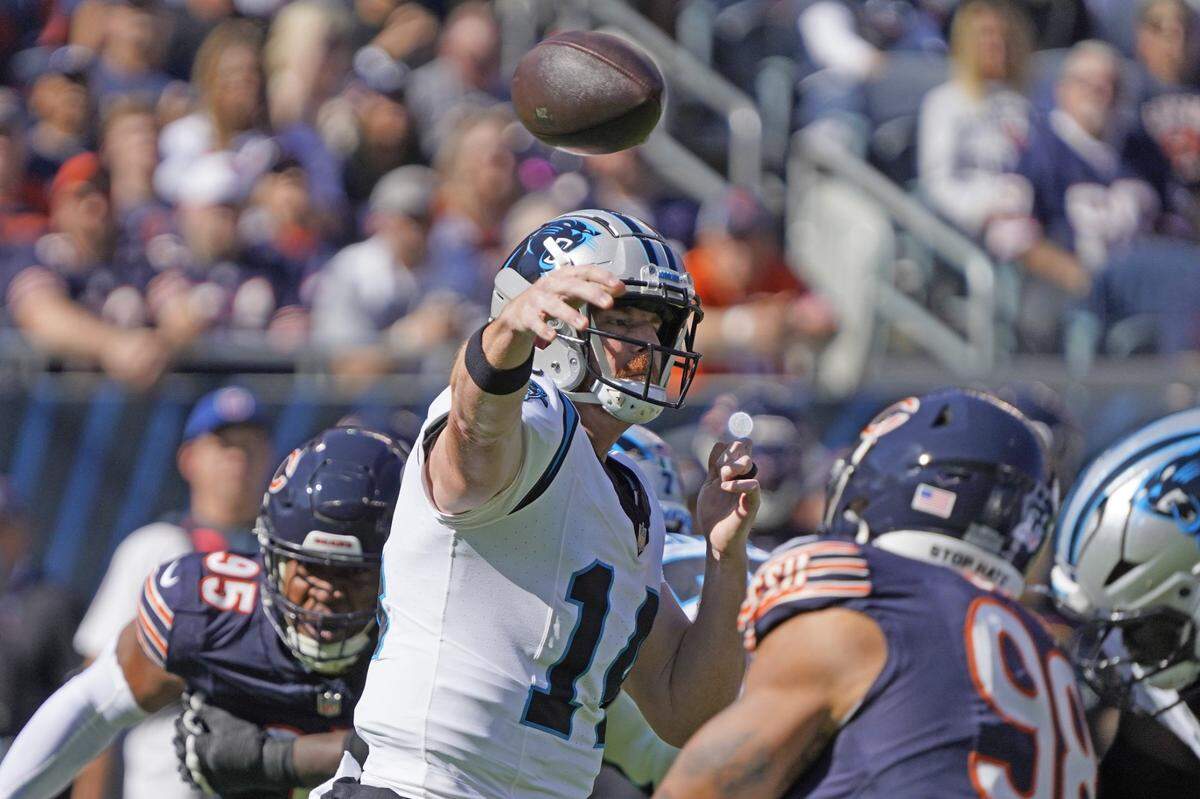 Oct 6, 2024; Chicago, Illinois, USA; Carolina Panthers quarterback Andy Dalton (14) passes against the Chicago Bears during the first half at Soldier Field. Mandatory Credit: David Banks-Imagn Images