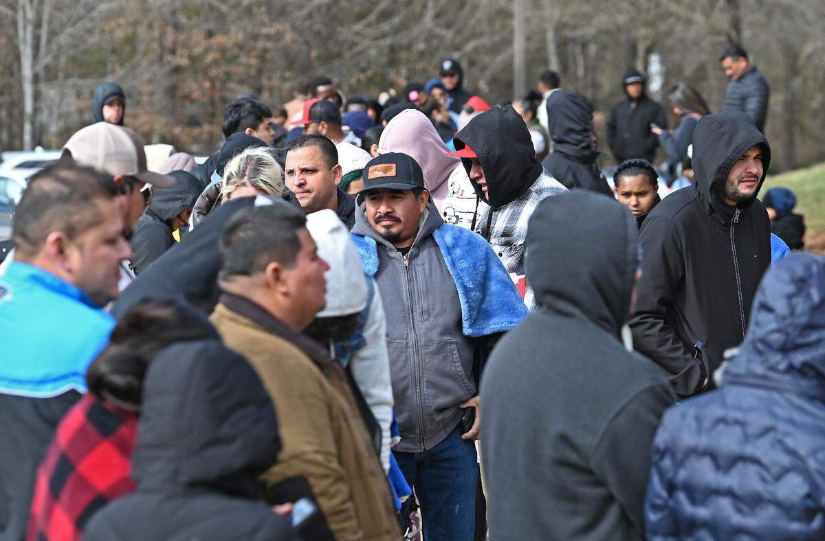 People wait outside the U.S. Department of Homeland Security office in Charlotte, NC on Thursday, January 16, 2025.