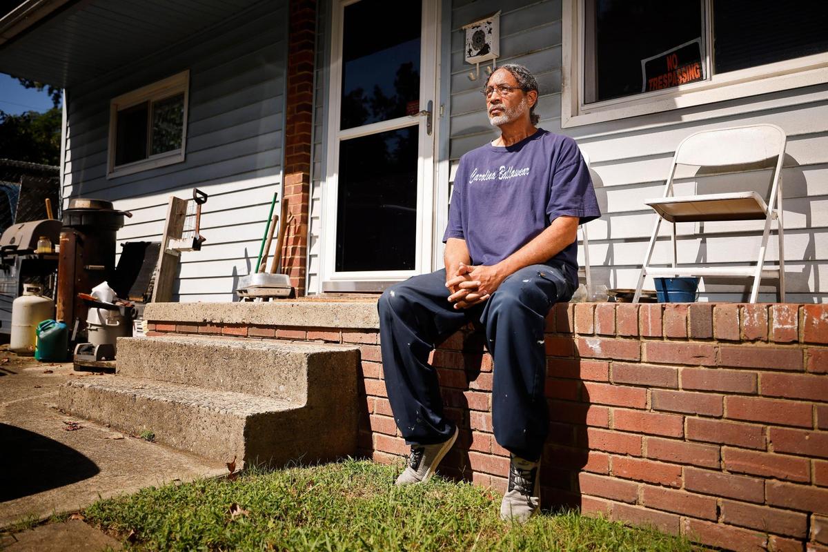 Ramone Holit, sits in front of his home on Ellenwood Place in Charlotte, N.C., on Tuesday, Sept. 13, 2022. The area around Holit’s home, where he has lived for 35 years, is rapidly developing and changing, leading to higher tax and insurance costs.