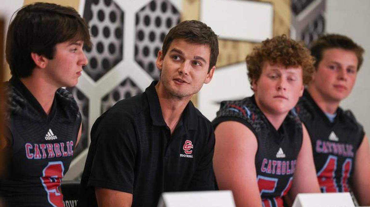 Charlotte Catholic football coach Matthew Reilly (center) is stepping down after one season.