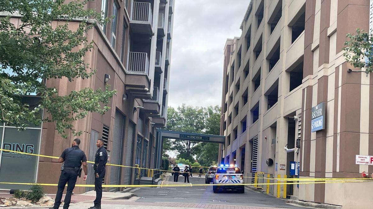 Charlotte Mecklenburg Police officers on the scene at N. Church Street and W. Tenth Street near The Ascher Uptown apartments  where a fellow officer was shot in the leg after responding to a domestic dispute in uptown Charlotte. 
