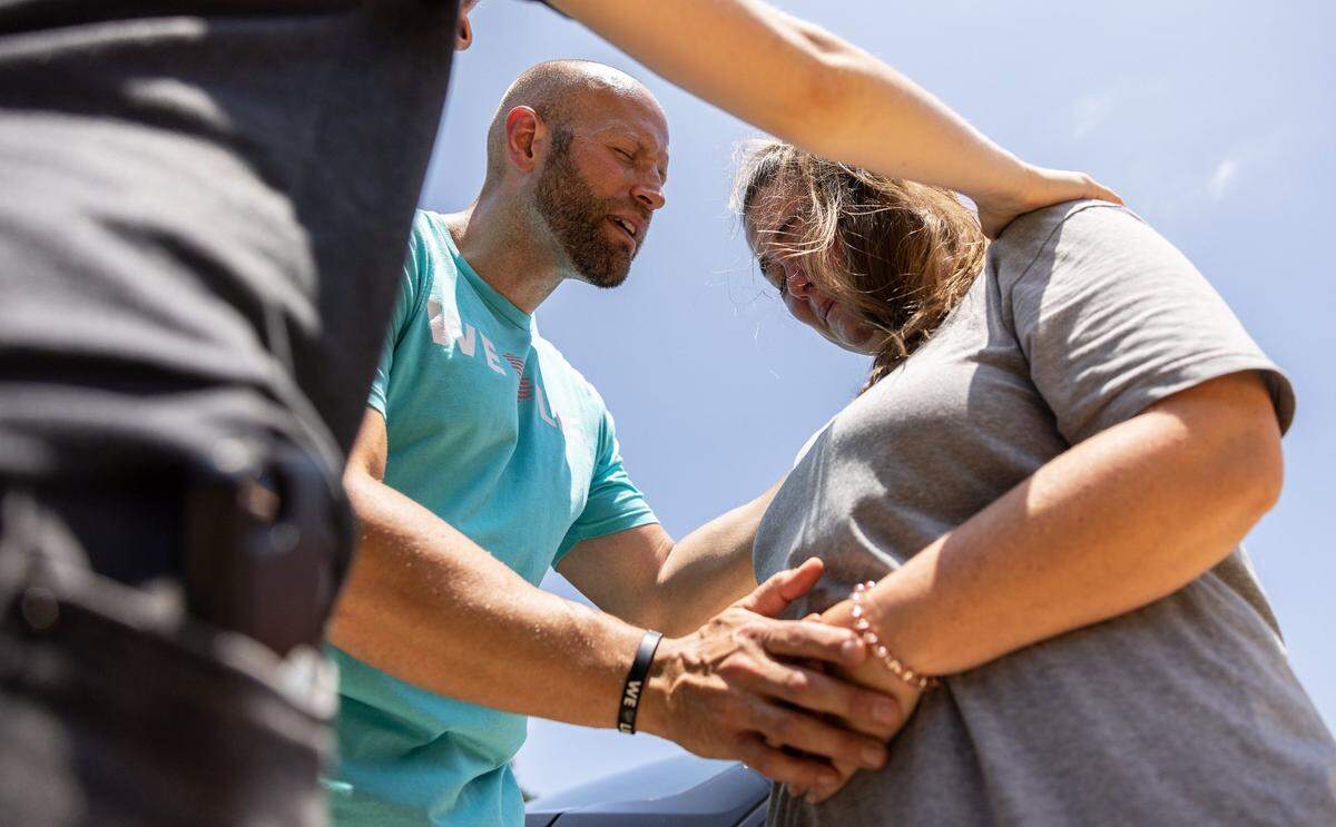 The anti-abortion group, Love Life, prays with a woman outside of A Preferred Women’s Health Center of Charlotte, June 25, 2022. The demonstration was in response to the U.S. Supreme Court’s decision to overturn Roe v. Wade.
