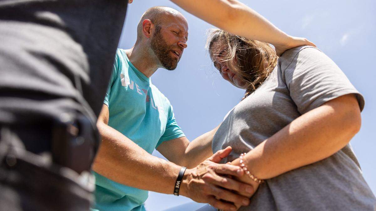 The anti-abortion group, Love Life, prays with a woman outside of A Preferred Women’s Health Center of Charlotte, June 25, 2022. The demonstration was in response to the U.S. Supreme Court’s decision to overturn Roe v. Wade.