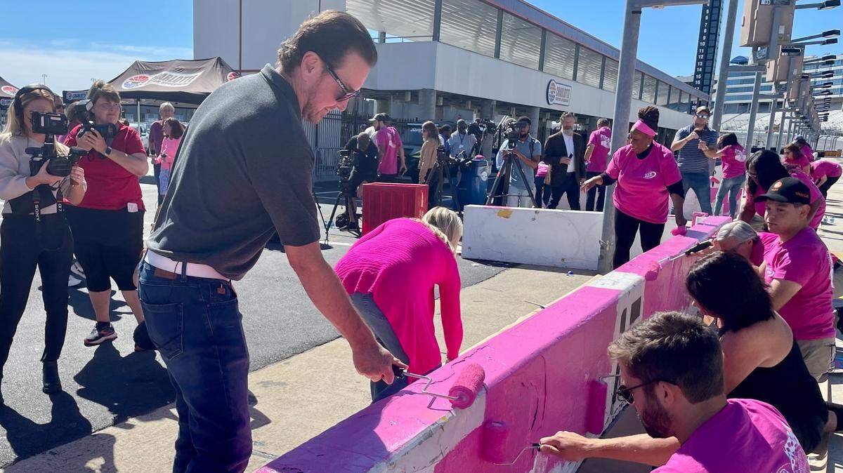 Kurt Busch paints a pit road wall at Charlotte Motor Speedway in Concord ahead of the NASCAR Cup Series playoff race on Oct. 9, 2022.