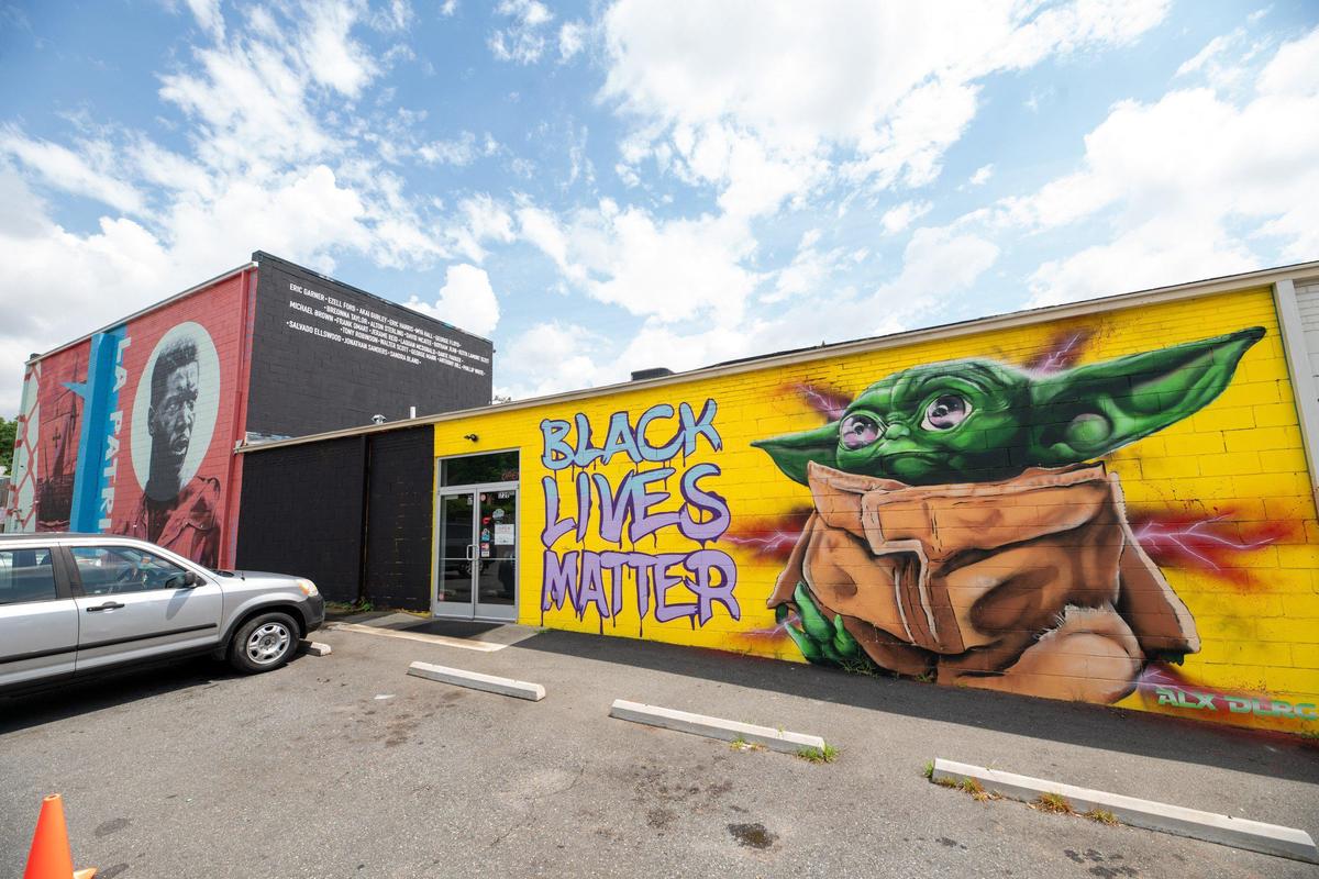 Alex DeLarge added Black Lives Matter to his Baby Yoda mural at Noda Deli. He will also be painting something in the black rectangle on the other side of the door, according to the NoDa Deli owner.