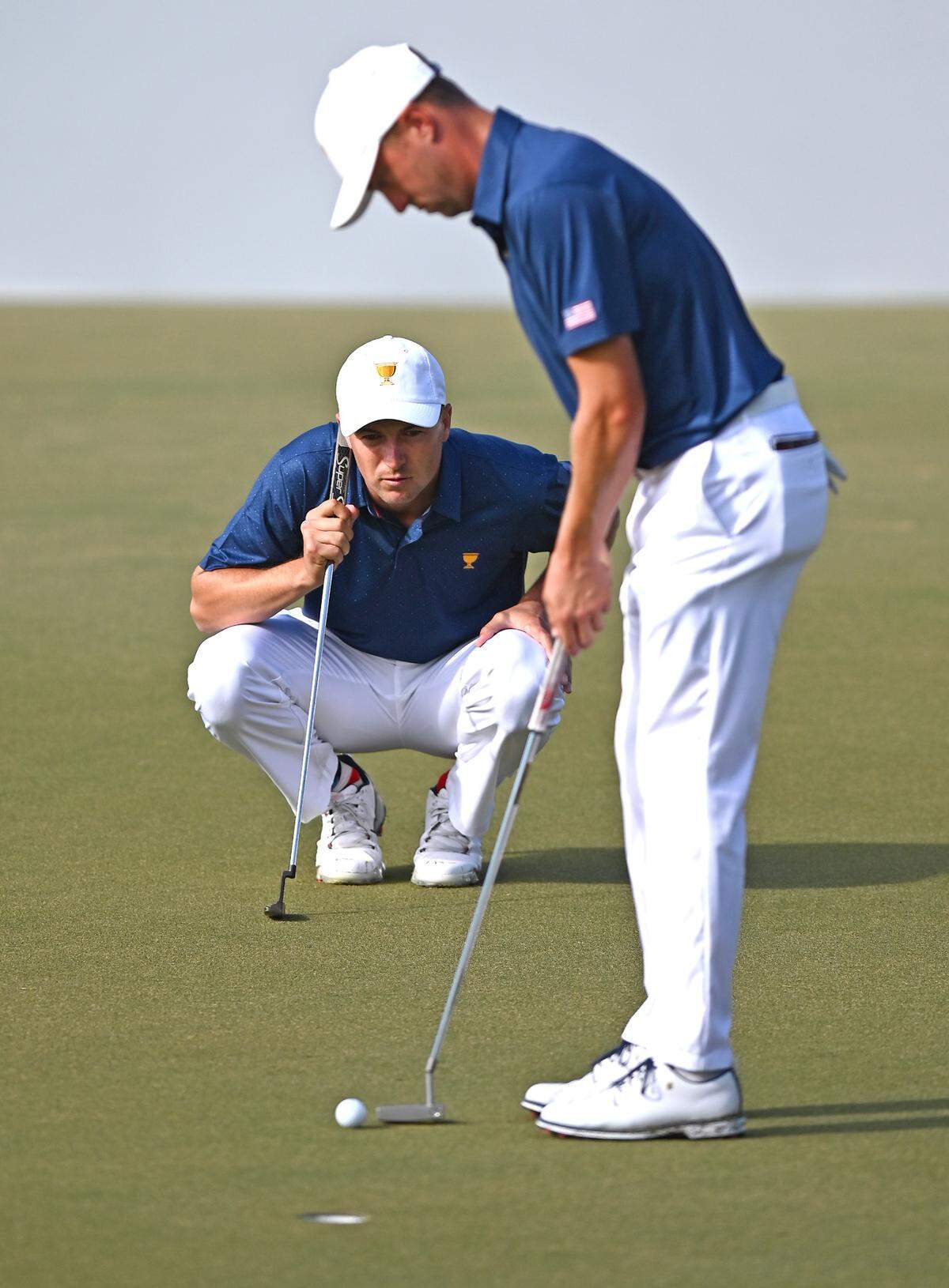 United States Team member Justin Thomas, right, helps teammate Jordan Spieth, left/crouching, line up a putt on the 11th green during third round action in the Presidents Cup at Quail Hollow Club in Charlotte, NC on Saturday, September 24, 2022.