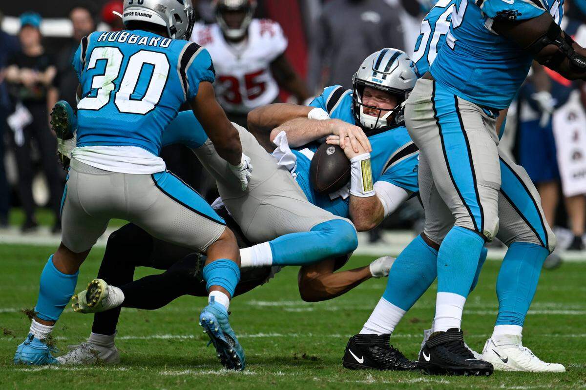 Carolina Panthers quarterback Sam Darnold is sacked by Tampa Bay Buccaneers safety Antoine Winfield Jr. during the first half of an NFL football game between the Carolina Panthers and the Tampa Bay Buccaneers on Sunday, Jan. 1, 2023, in Tampa, Fla. (AP Photo/Jason Behnken)