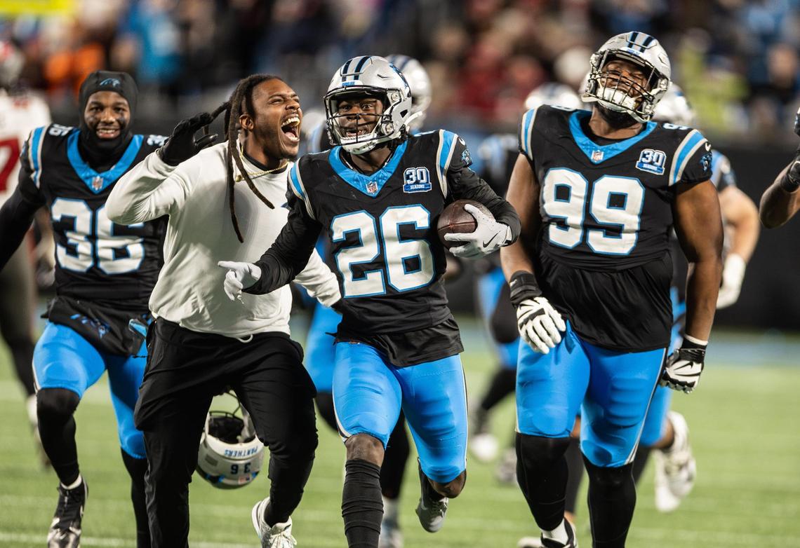 Carolina Panthers special teams assistant coach Daren Bates (middle left) celebrates with cornerback Chau Smith-Wade and his teammates following an interception against the Tampa Bay Buccaneers at the Bank of America Stadium in Charlotte, N.C., on Sunday, December 1, 2024.