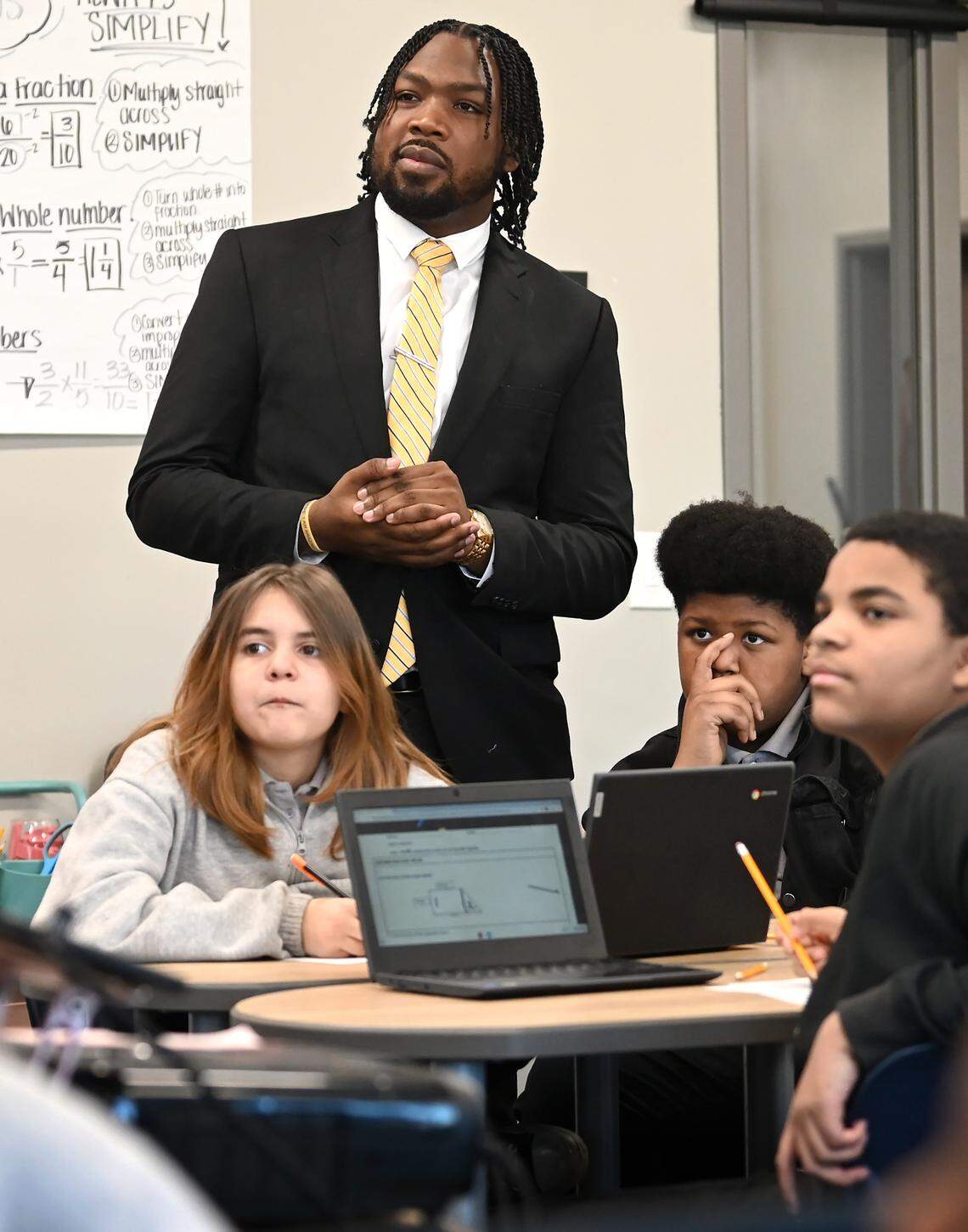 Kenneth Gorham, left, listens in on a sixth grade class on Tuesday, January 10, 2023. Gorham is the principal of Movement Freedom Middle School in Charlotte, NC. Gorham is only 25 years old and is the youngest principal in the charter school’s history.