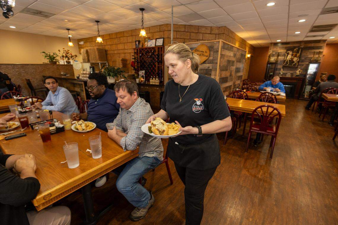 Amy Tower serves guests at House of Pizza.