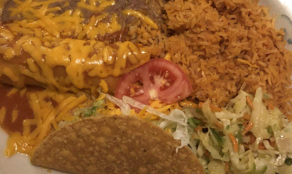 Azteca’s taco and enchilada combination comes with rice, refried beans and slaw.