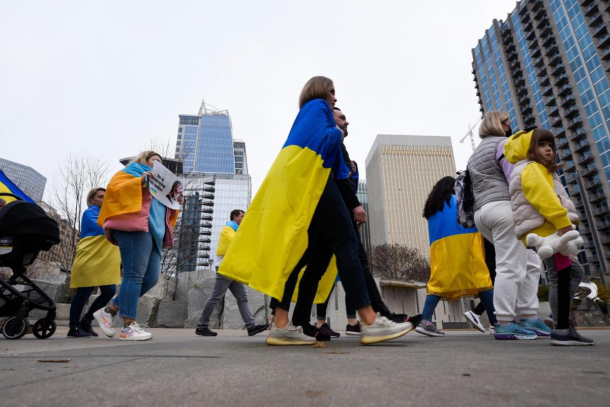 About 200 people show their support for Ukraine during a gathering at at Romare Bearden Park in Charlotte, N.C. Thursday, Feb. 24, 2022.