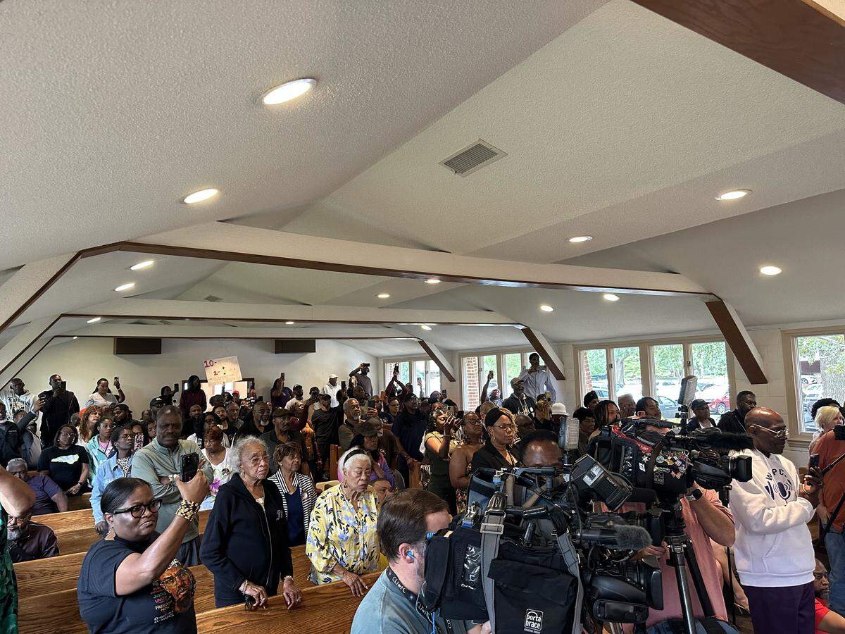Attendees at a press conference in Shelby on Tuesday, June 2, 2026, called for justice for Cherrie Moore after a police officer was charged with assaulting her.