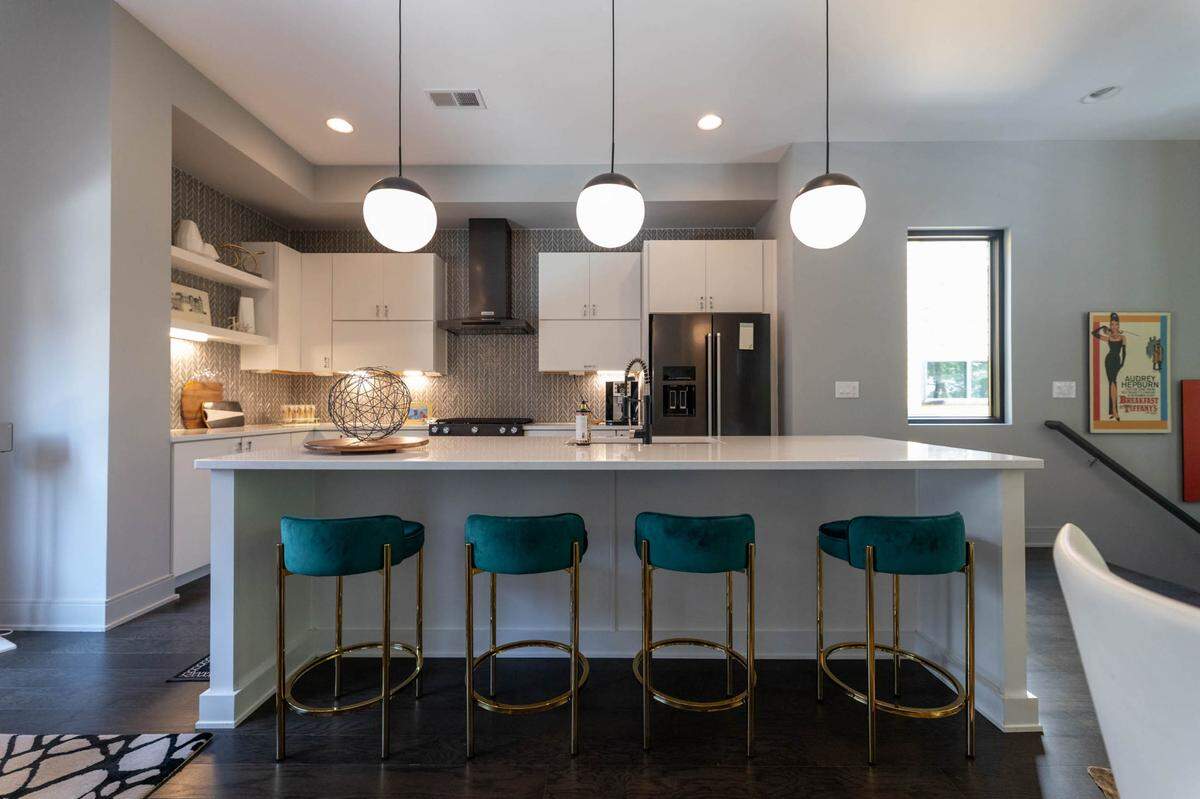 The kitchen island at Craig and Rachel Richards’ NoDa home has built-in space for bar seating.