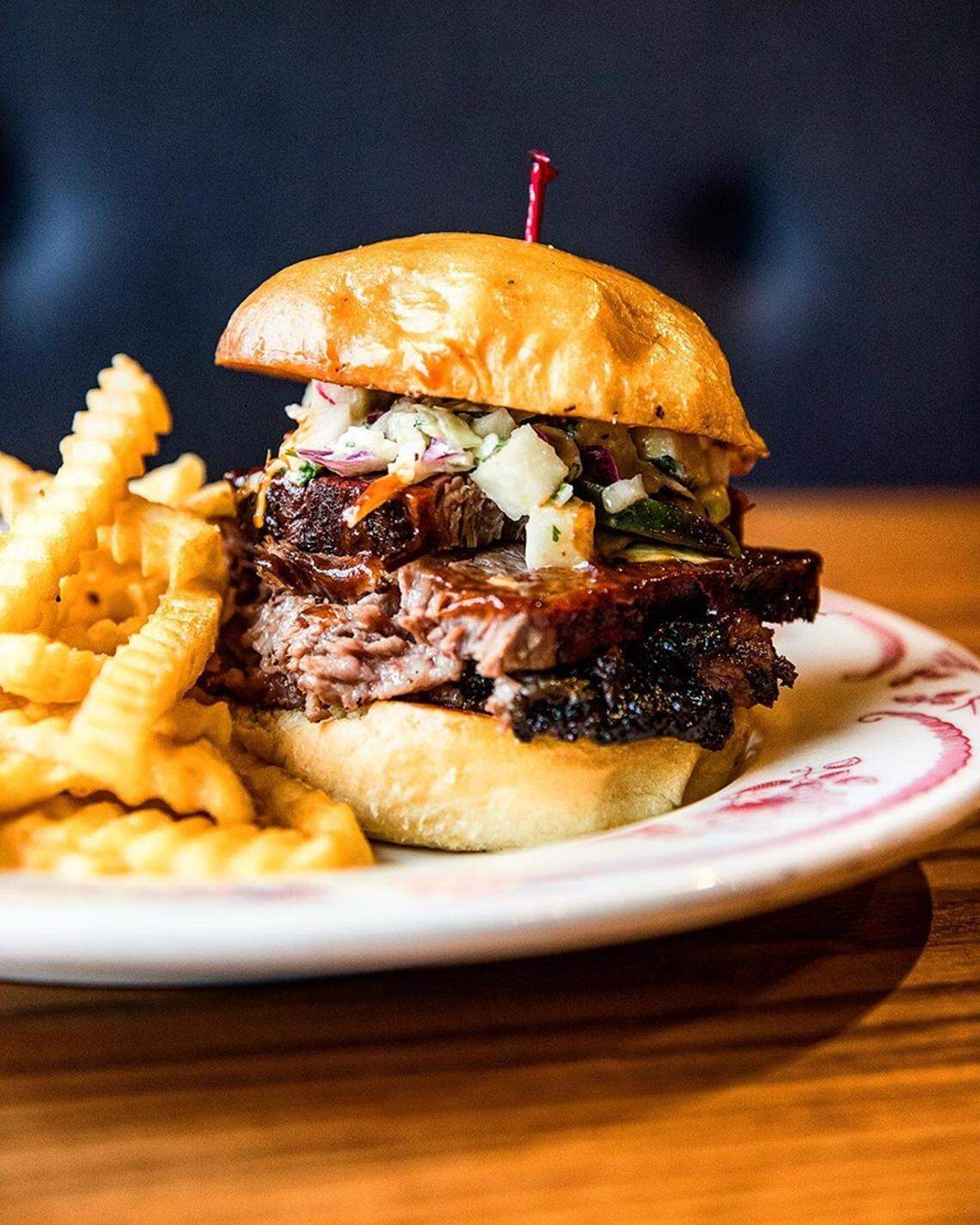 The Fat Matt sandwich features sliced brisket, apple-jalapeño slaw and Midwood sauce on a brioche bun