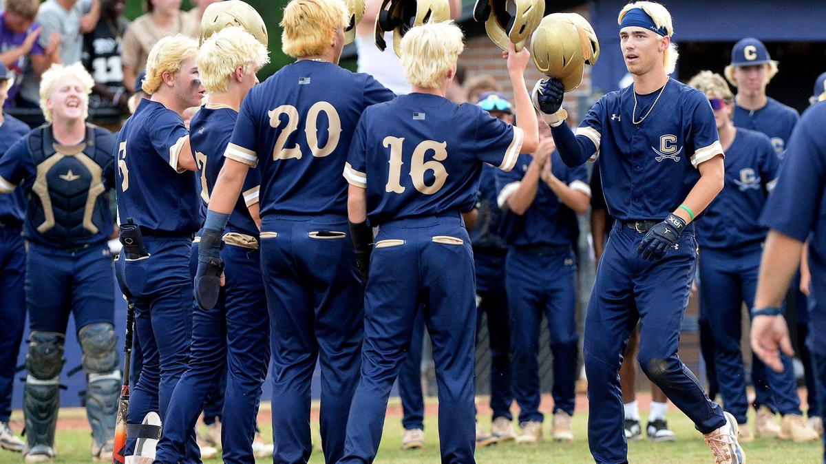 Cuthbertson’s Logan James, is greeted at home plate after slugging a grand slam in the first inning against T.C. Roberson in Waxham on Tuesday, May 20, 2025.