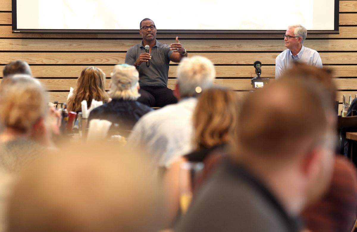 Former Carolina Panthers defensive end Mike Rucker, left, talks about his career and the current team as Charlotte Observer sports columnist Scott Fowler, right, looks on during The Charlotte Observer’s preview for the upcoming season on Monday, August 5, 2024 at Olde Mecklenburg Brewery & Biergarten in Ballantyne.