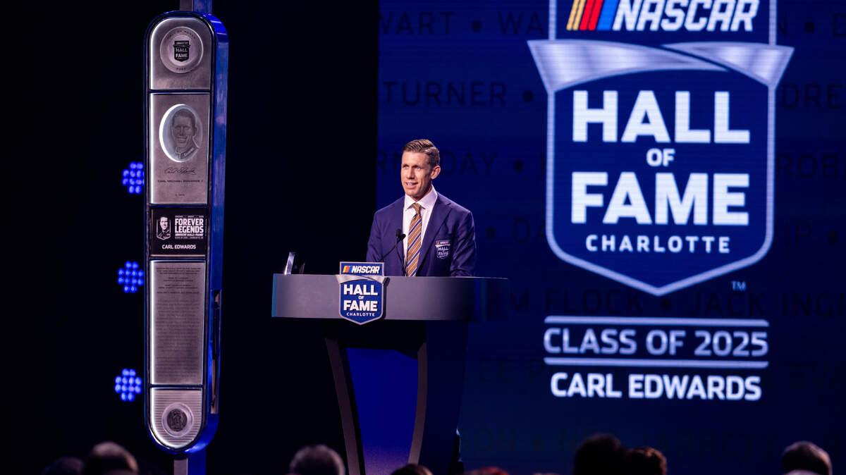 Feb 7, 2025; Charlotte, NC, USA; Former driver Carl Edwards accepts his induction into the NASCAR Hall Of Fame at Charlotte Convention Center Crown Ballroom.