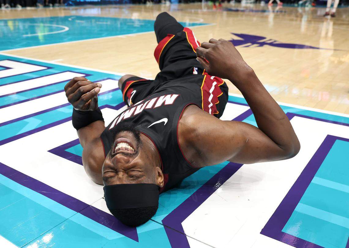Miami Heat forward/center Bam Adebayo grimaces in pain after falling to the court during action against the Charlotte Hornets at Spectrum Center in Charlotte, NC on Tuesday, April 14, 2026. The Hornets defeated the Heat 127-126.