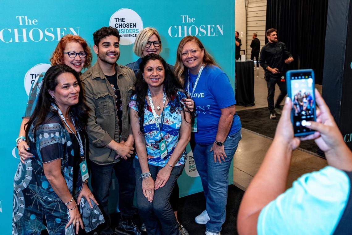 Attendees snap photos with actors Paras Patel (Matthew) and Elizabeth Tabish (Mary Magdalene) during ChosenCon 2024.