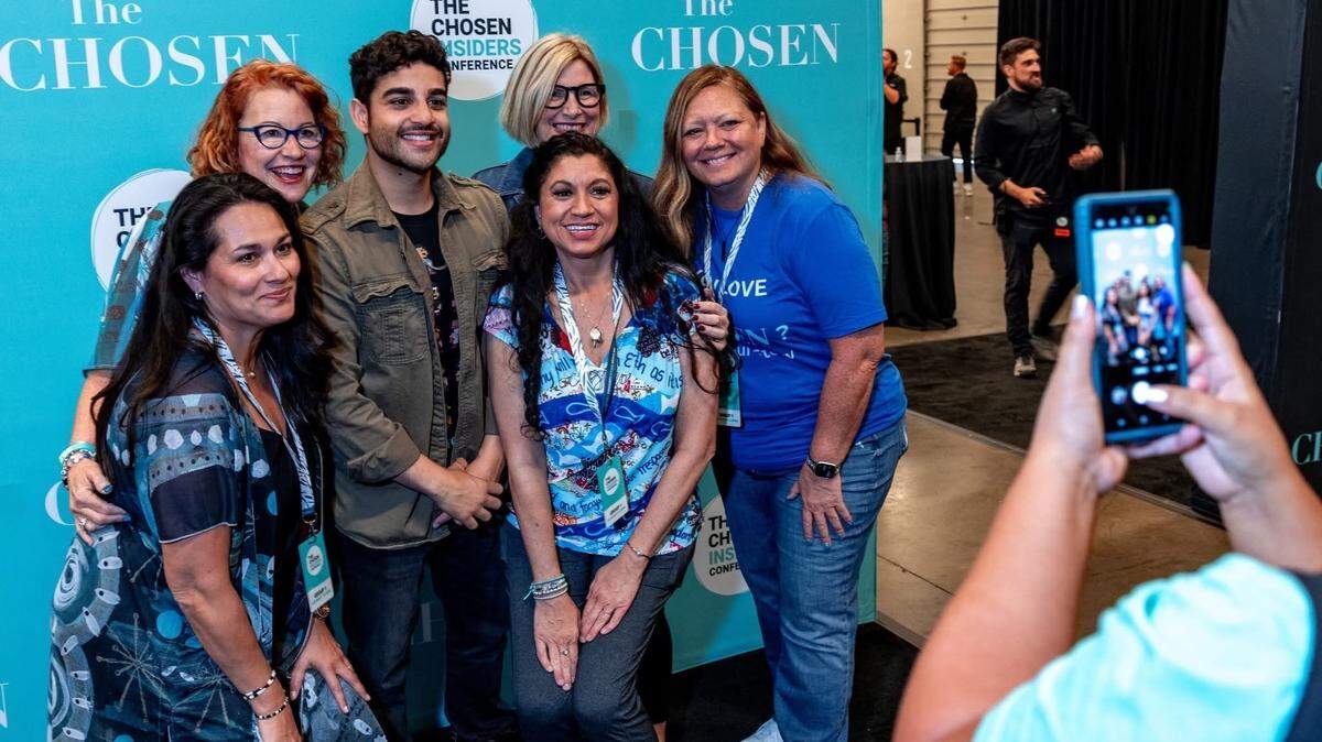 Attendees snap photos with actors Paras Patel (Matthew) and Elizabeth Tabish (Mary Magdalene) during ChosenCon 2024.
