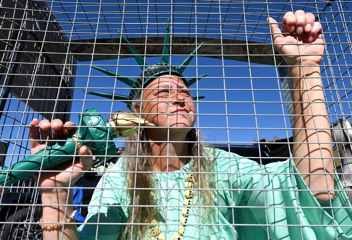 Shana Blake of Charlotte, NC dressed as The Lady Liberty protests outside Manolo’s Bakery on Central Avenue on Monday, November 17, 2025. Manolo’s has closed temporarily due to the presence of U.S. Customs and Border Patrol agents in the city. “Even if [the bakery’s] not open, it’s such a faith effort to have people show up and support,” Blake said.