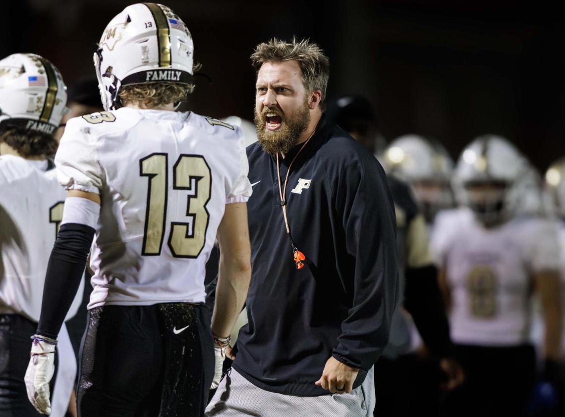 Panther head coach Weslee Ward (center) has a discussion with Shawn Matthews (13) after his touchdown catch. South Meck hosted the Providence Panthers on Friday November 8, 2024.