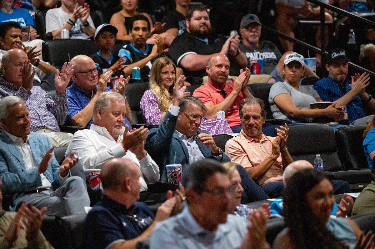 The former governor of North Carolina Pat McCrory raises his hand while the audience applauds him during the premiere of The Charlotte Observer’s movie ‘Supermen’ at the Independent Picture House in Charlotte, NC, Thursday July 24, 2025.