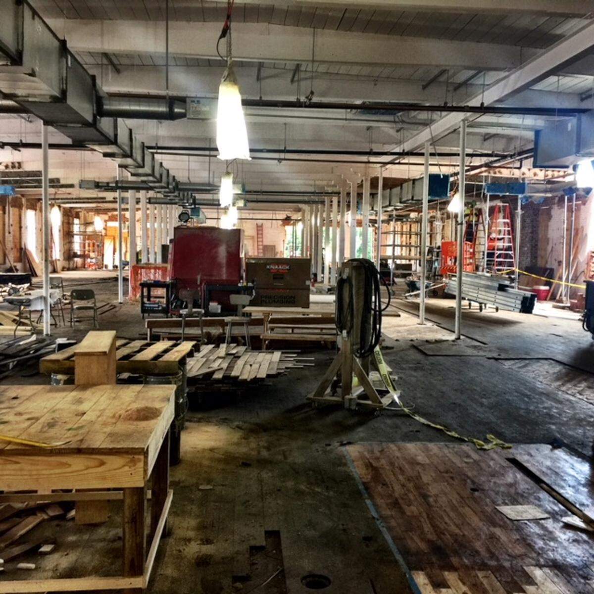 The  Tompkins Hall project, restoring a former textile mill in the NoDa area, will include a food hall of vendors in the center. The original floors  and windows are being restored to accommodate food vendors.