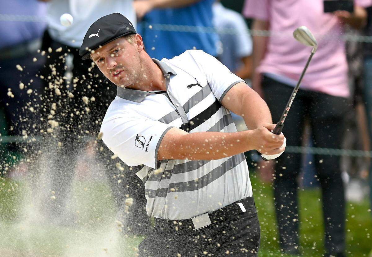 Golfer Bryson DeChambeau hits from a sand trap at the PGA Tour event in Charlotte in 2021.
