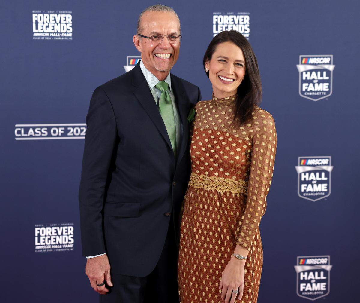 Former NASCAR driver Kyle Petty and wife Morgan, right, pose for photographs along the red carpet at the NASCAR Hall of Fame on Friday, January 23, 2026.