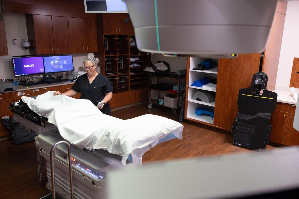 Lauren Freer prepares a radiation therapy room for a patient at Novant Health Huntersville Medical Center.