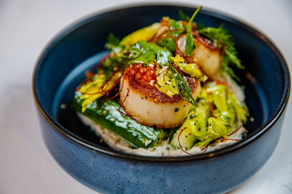 Pan roasted scallops: Cream cheese spread, cucumber salad, everything seasoning, smoked trout roe at Rosemont Market & Wine Bar.
