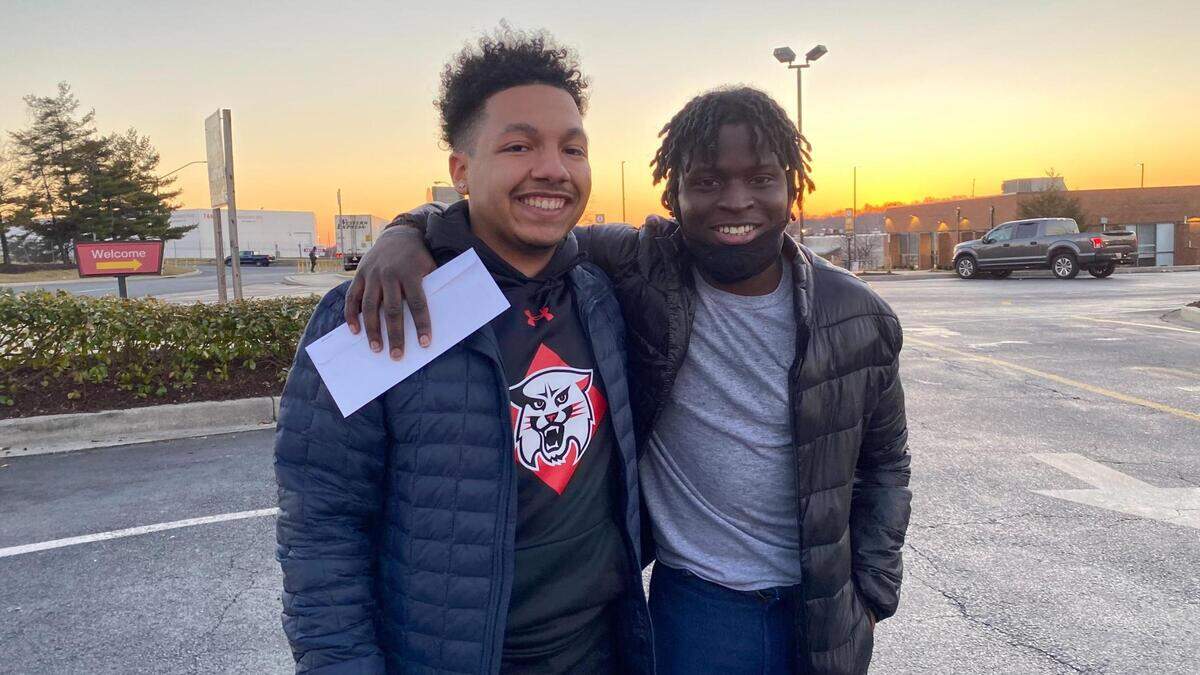 Davidson College senior Brandon Harris, left, is shown with childhood friend Sura Sohna outside a McDonald’s restaurant minutes after Sohna’s release from a Maryland prison on Tuesday, Feb. 8, 2022.