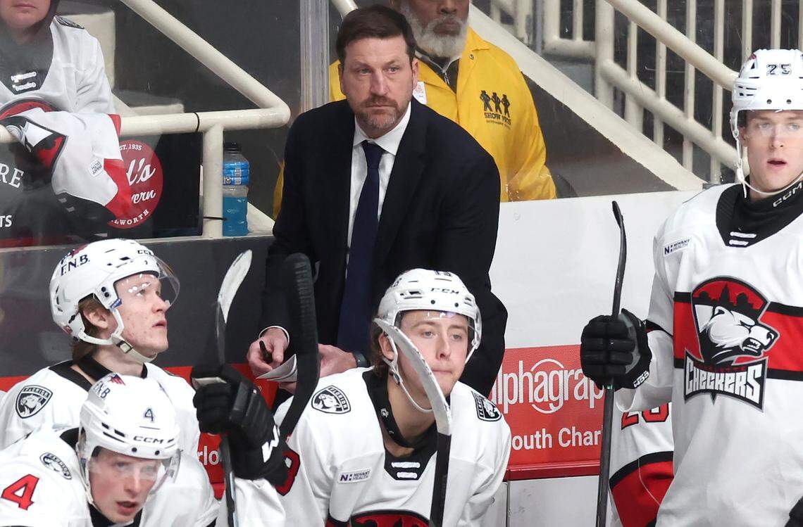 Charlotte Checkers head coach Geordie Kinnear, center, team battle the Iowa Wild on Friday, October 17, 2025 at Bojangles Coliseum in Charlotte, NC.