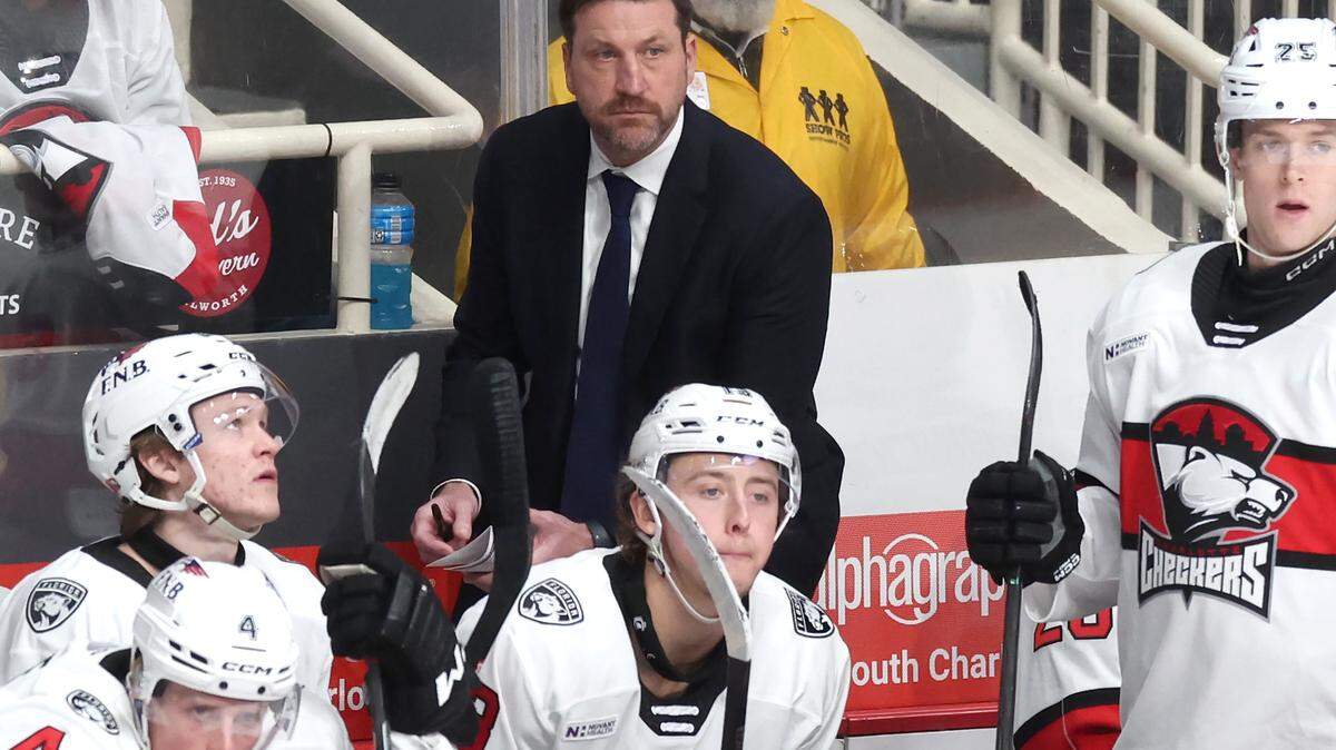 Charlotte Checkers head coach Geordie Kinnear, center, team battle the Iowa Wild on Friday, October 17, 2025 at Bojangles Coliseum in Charlotte, NC.