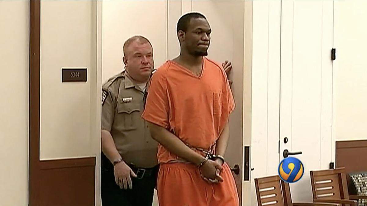 Devalos Perkins is escorted into the courtroom for a hearing in 2018. Perkins was in custody for more than 11 years despite never being found guilty. That ended Thursday when he pleaded guilty and a judge ordered his release.