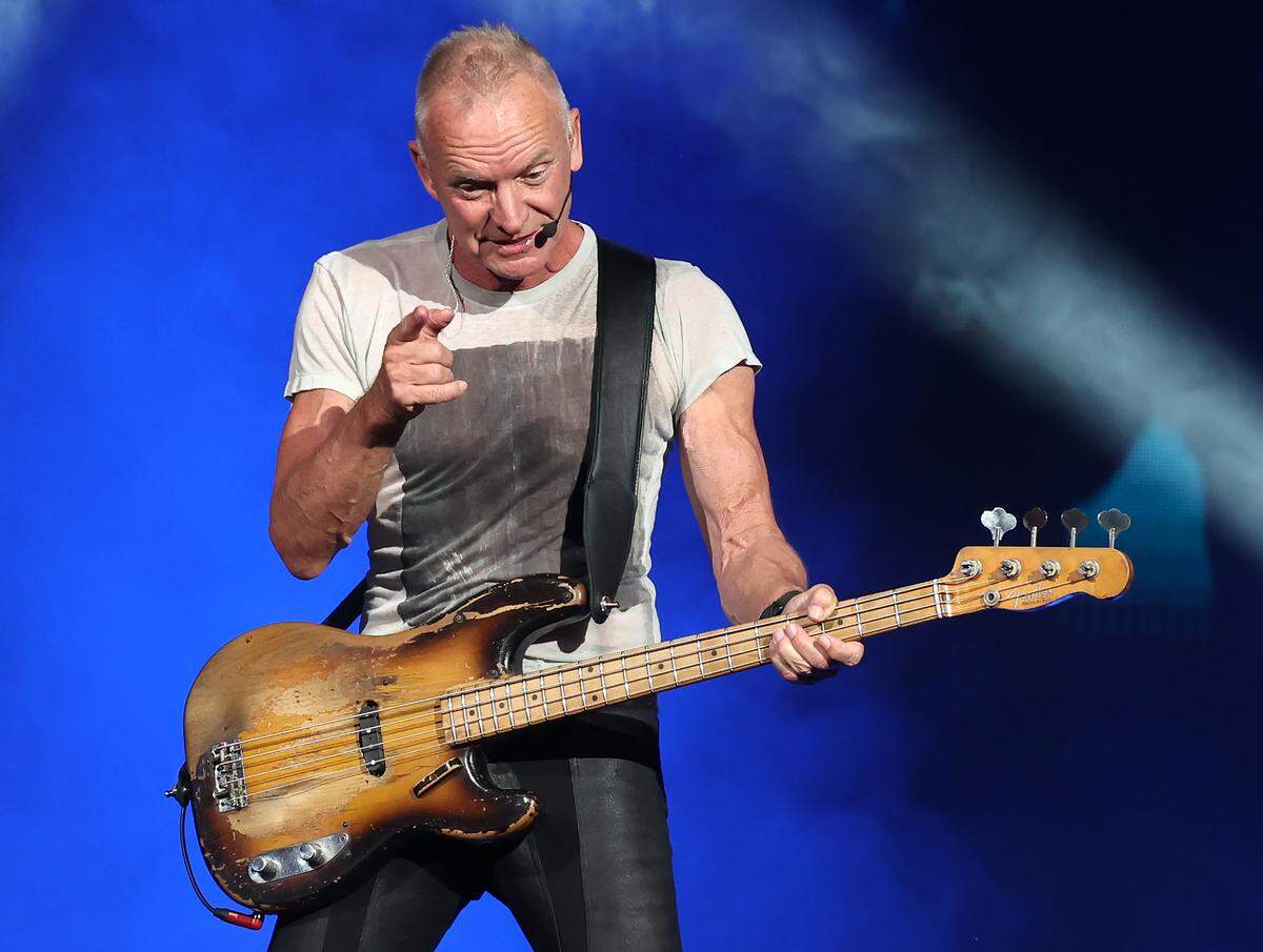 Sting gestures at a fan in the crowd during his “Sting 3.0” tour at Truliant Amphitheater in Charlotte on Monday night.