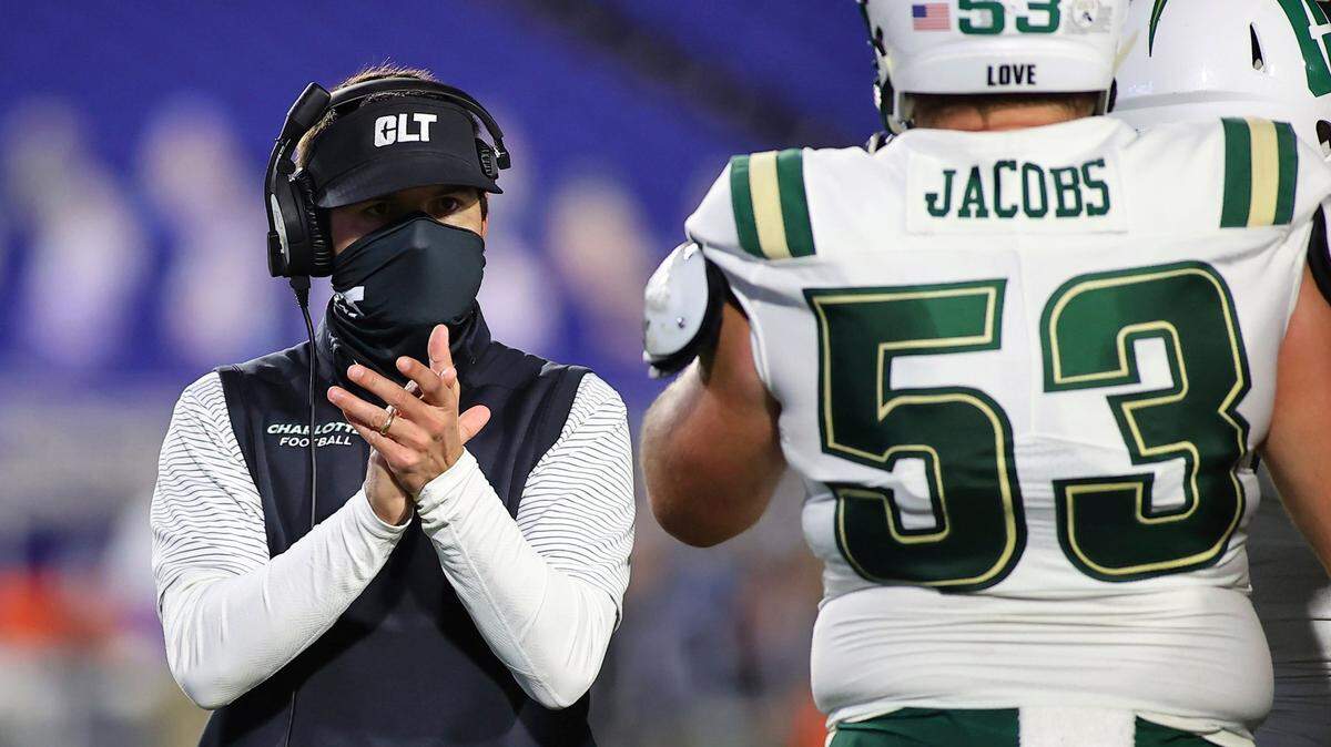 Charlotte coach Will Healy applauds during the first quarter of the team’s NCAA college football game against Duke on Saturday, Oct. 31, 2020, in Durham, N.C. (Jaylynn Nash/Pool Photo via AP)