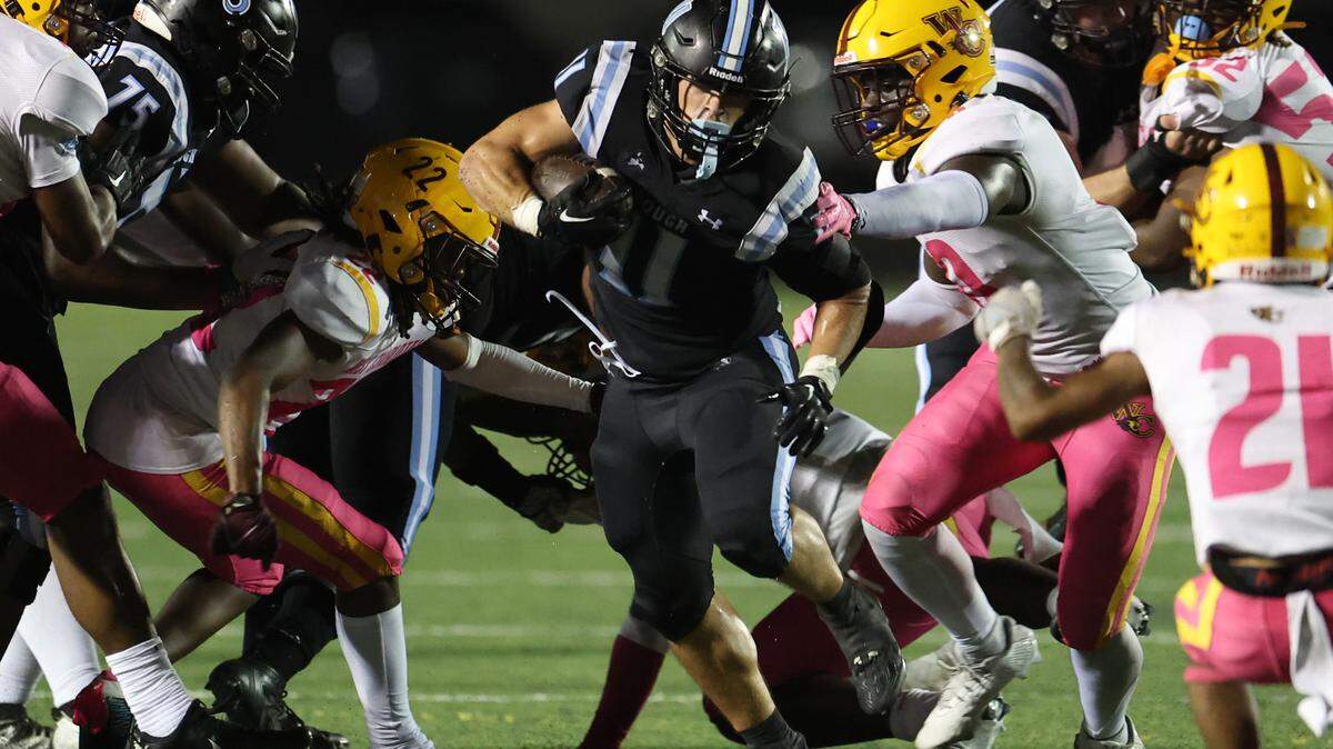 Hough Huskies Will Jones, center, breaks through a hole in the West Charlotte defense during second half action on Friday, October 6, 2023.
