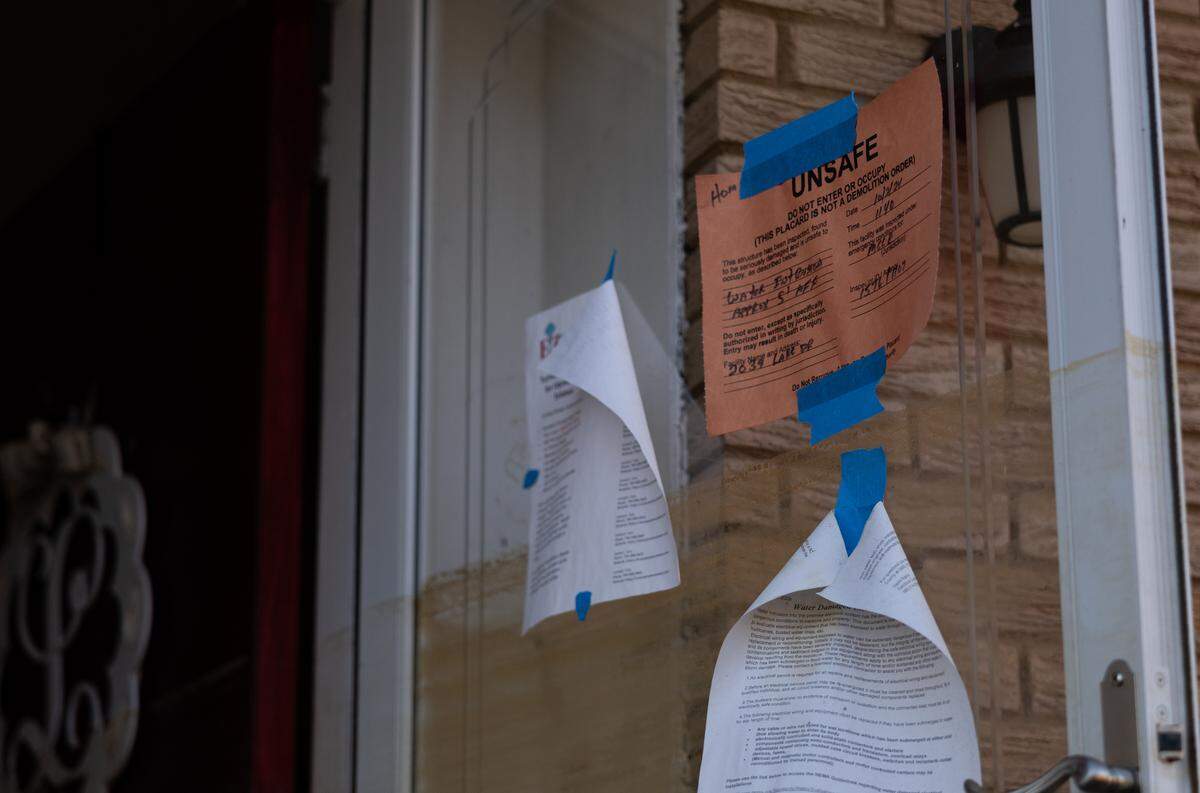 An “unsafe” note posted by a county inspector on the door of Macie Kinley’s flood-damaged home on Lake Drive in Charlotte.