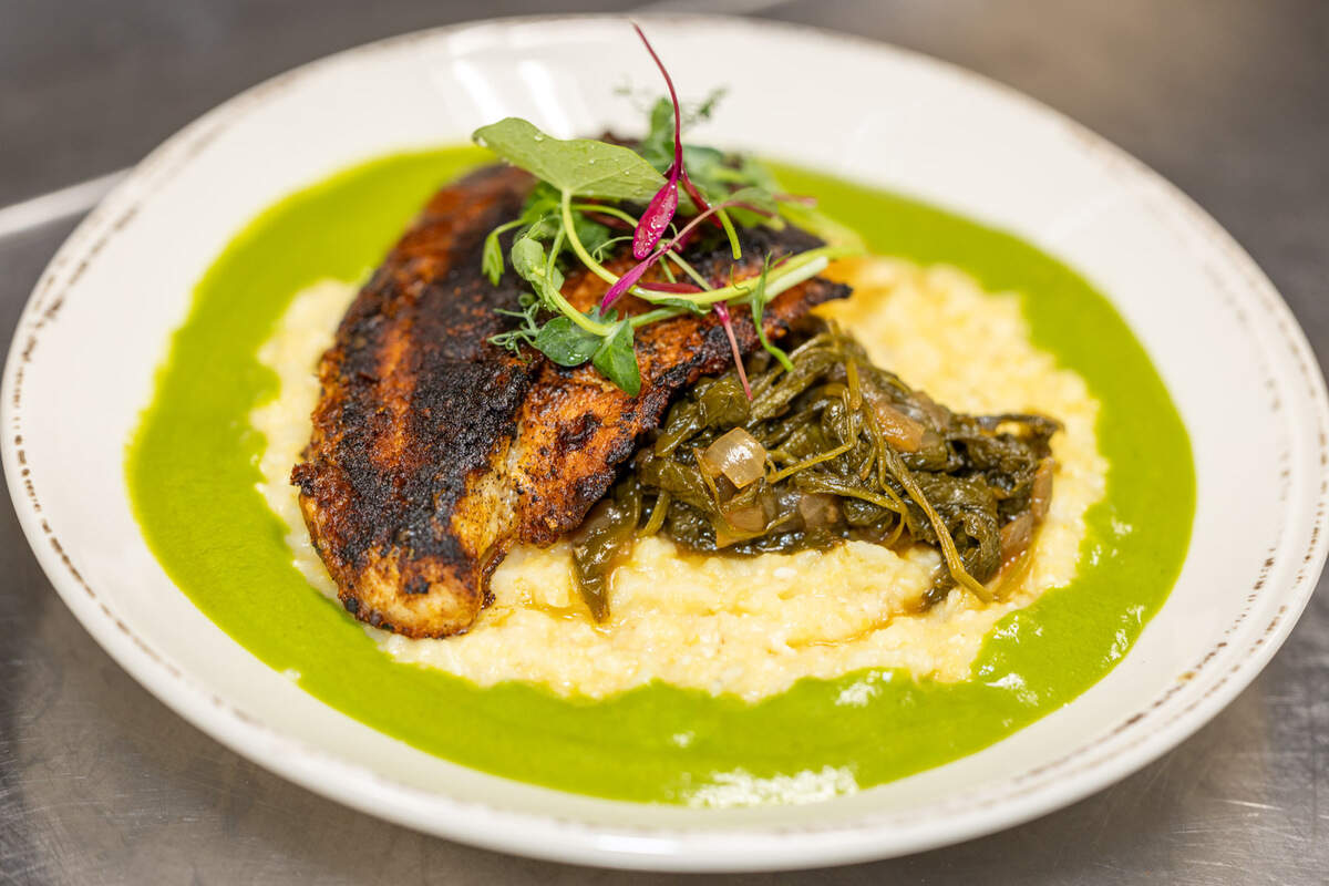 Catfish & Grits at Community Matters Cafe comes with blackened catfish, grits, braised mustard greens and parsley gravy.