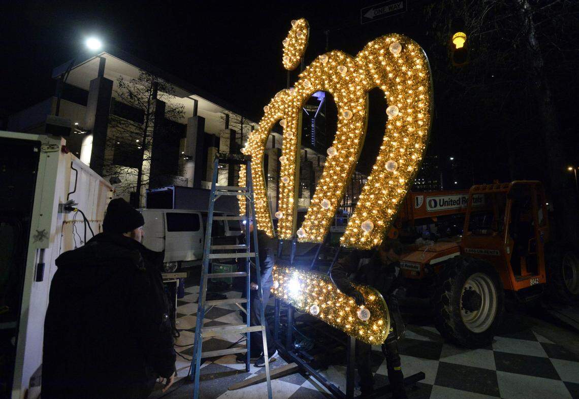 Workers test the lights on the crown backstage at Charlotte’s New Year’s celebration on Dec. 31, 2014.